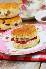 Traditional scone with strawberry jam and clotted cream
