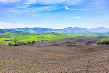 View in Tuscany with newly seeded fields in rural landscape