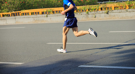 Fototapeta premium fitness male marathon runner running on city road