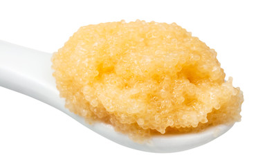 salty yellow caviar of capelin in ceramic spoon