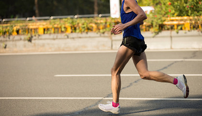 Plakat fitness male marathon runner running on city road