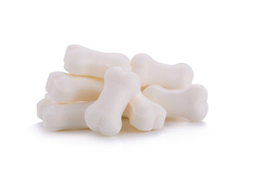 Milk pellet in the shape of a bone on white background.