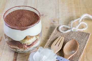 tiramisu cake homemade on wooden background. fork and spoon