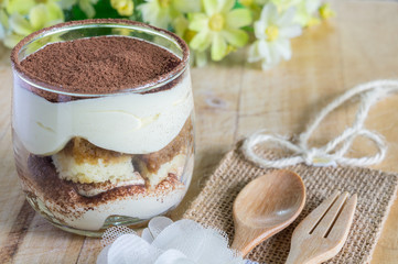 tiramisu cake homemade on wooden background. fork and spoon
