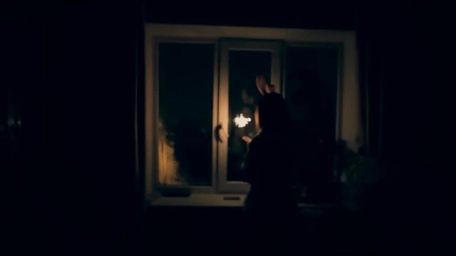 Home video - girl with sparklers celebrating new year at window