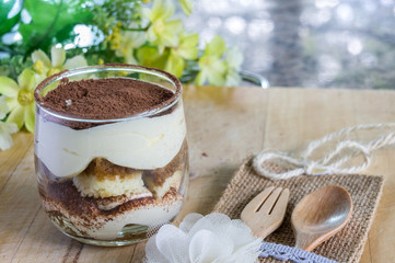 tiramisu cake homemade on wooden background. fork and spoon