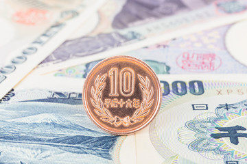 Japanese money 10 yen coin on banknote close-up