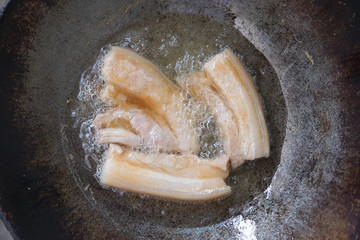 Top view oil in pan and fried pork