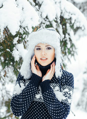 Portrait of a beautiful girl in a winter forest