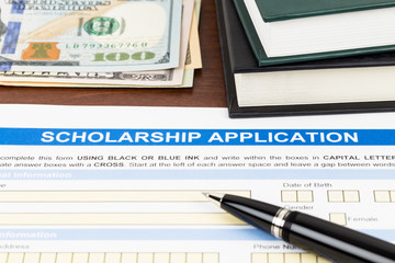 Scholarship application form with pen, dollar banknote and text