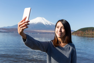 Woman capture photo by herself with mobile phone