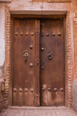 The tipical door of red mud-brick houses in the ancient village of Abyan, in Iran
