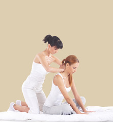 Woman on a Thai massage on a beige background