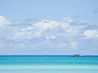 Fishing boat in the azure sea in calm weather.