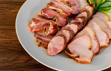 sliced pork  sausage  ham bacon wooden textured table in restaraunt.