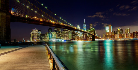 New York City Brooklyn Bridge and Manhattan skyline Hudson River illuminated