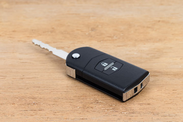 Modern remote car key on wooden background