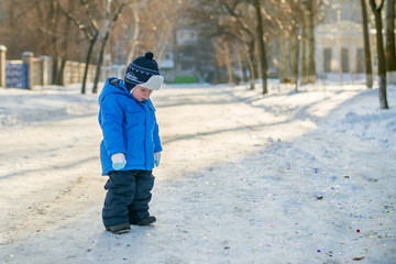 winter sad boy walking on a snowy street © spyrakot