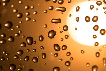 Water drops on the glass at sunset