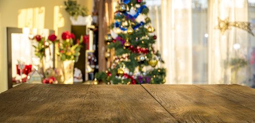 christmas table background with christmas tree out of focus