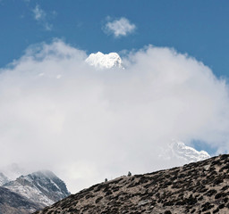 Top of the Tabuche peak in the clouds from the village of Dingboche in the valley of Chhukhung...