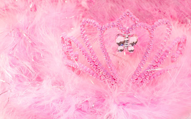 Pink dress up tiara lost in a sea of pink feather boas