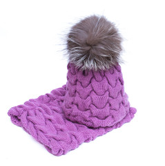 Violet knitted woolen scarf and hat with pompom isolated on white background.
