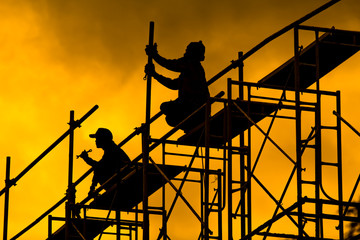 Construction site and workers on yellow background