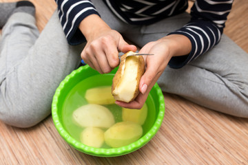 woman peeling potatoes