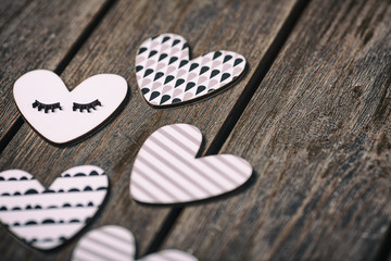 A wooden hearts on a wooden background. Valentines day background. Selective focus.