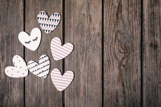 A wooden hearts on a wooden background. Valentines day background. Top view.