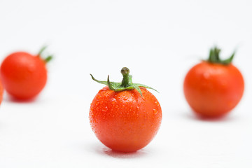 One of Fresh cherry tomato on water