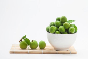 Wet korean green plum fruits on a bowl 