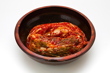 Kimchi in a crock head isolated on white background