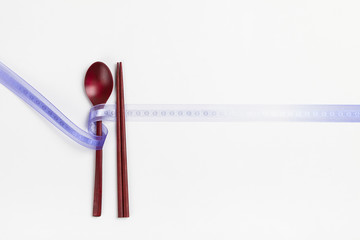 Wood spoon and chopsticks on white background