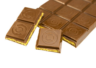 a broken tile with caramel filling of chocolate isolated on whit