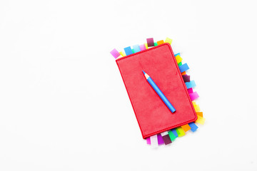 Red copybook with blue pen 