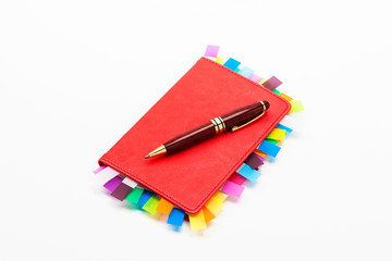 Red copybook with red pen