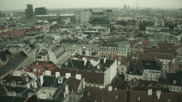Low-rise and modern buildings' roofs in Vienna on a hazy day, Austria