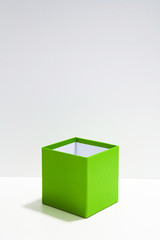 Open Green cube on white illuminate place