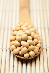 Soybeans and wood spoon on wood