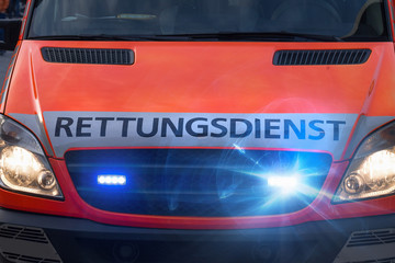 german ambulance car with flashing warning lights © Tobias Arhelger