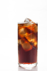 Cola with ice in a glass on white background