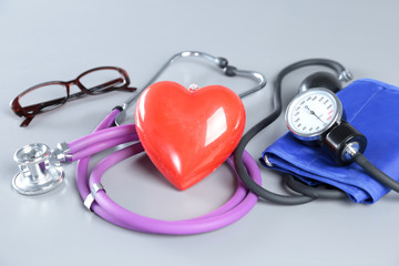 Fototapeta na wymiar Red heart and a stethoscope on white background