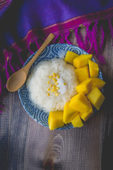 Thai Dessert Sweet Sticky Rice with Mango on Old Wooded