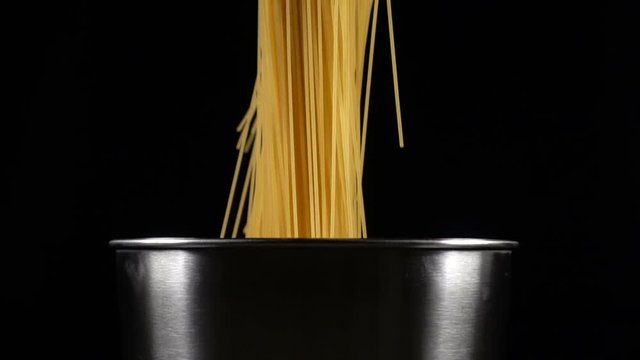 bunch of spaghetti falls in a pot
