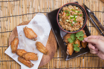 Chef decorated fried chicken wings served with fry rice