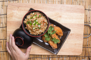 Fried chicken wings served with fry rice