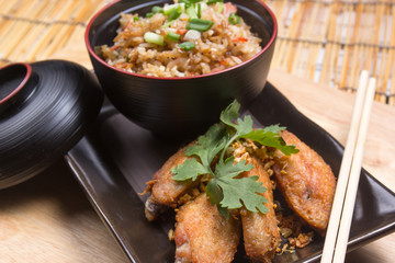 Fried chicken wings served with fry rice