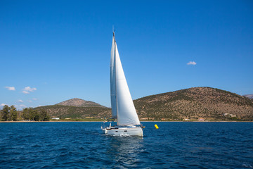 Fototapeta na wymiar Sailing ship luxury yacht boat with white sails in the Sea.